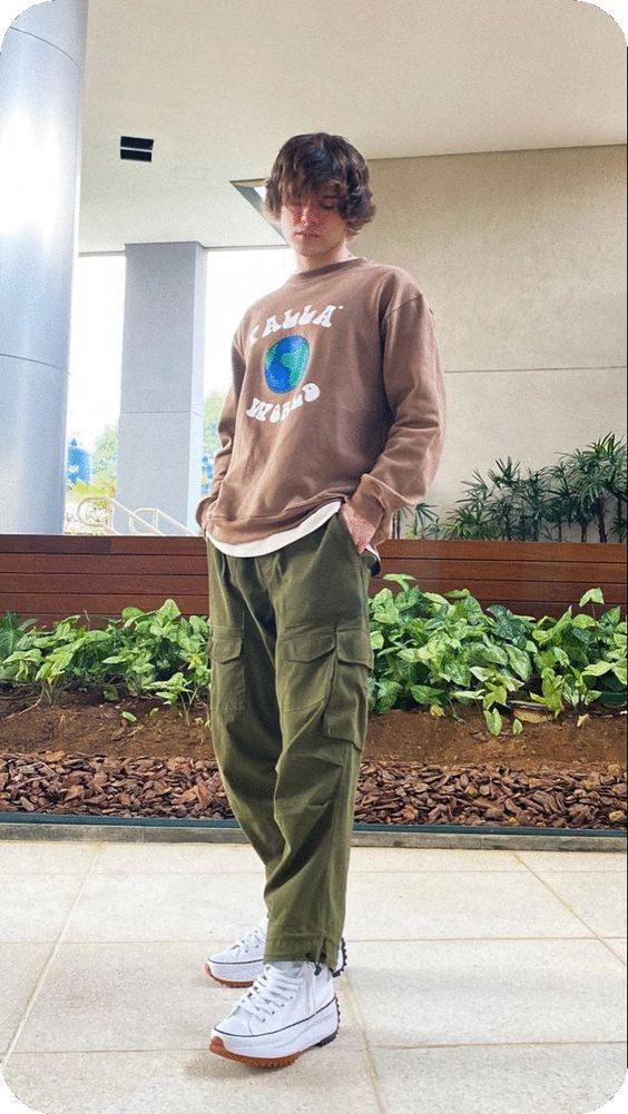 Brown graphic sweatshirt over white tee, green cargo pants